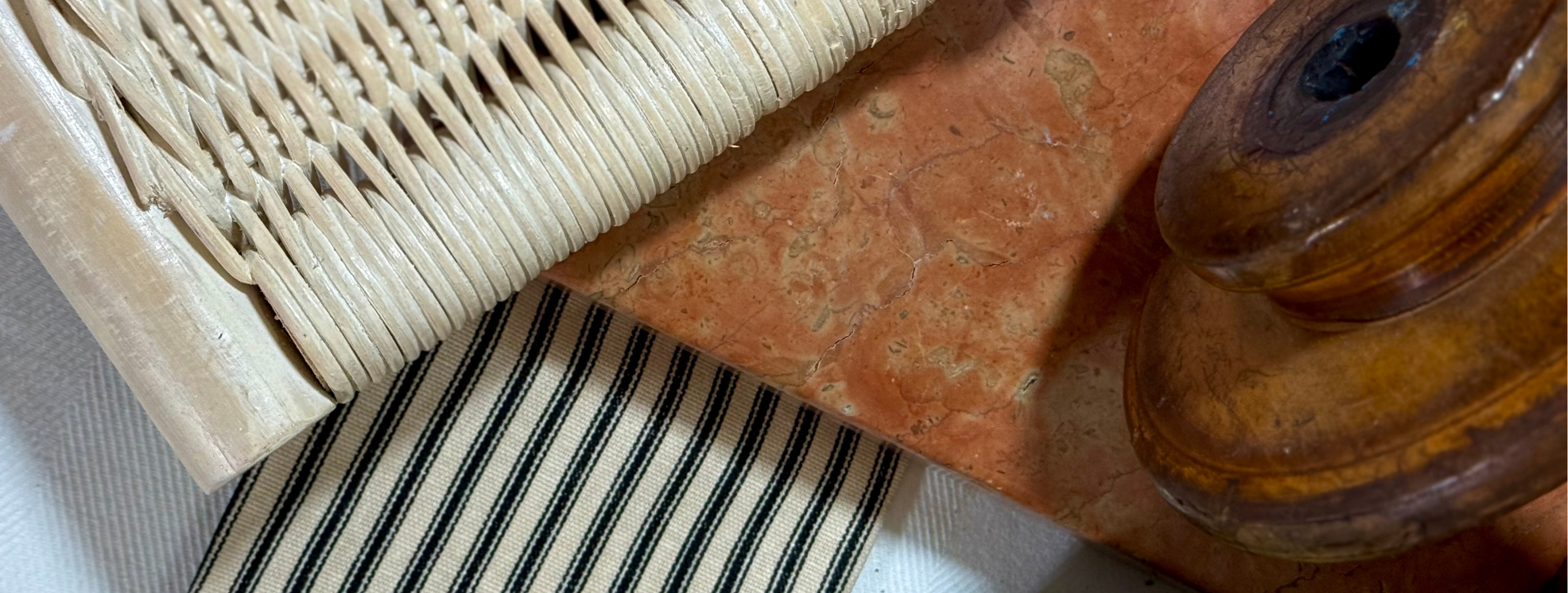 Close-up of a woven mat with a wooden reel on a textured surface